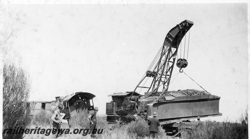 P22260
Derailment at169 mile near Bruce Rock YB line No 3 of 7, Cravens 25 ton  breakdown crane no.23 lifting tender, onlookers, ground level view
