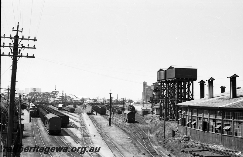 P22272
Bunbury yard looking west, Roundhouse and water tanks in photo. X class in platform. SWR line
