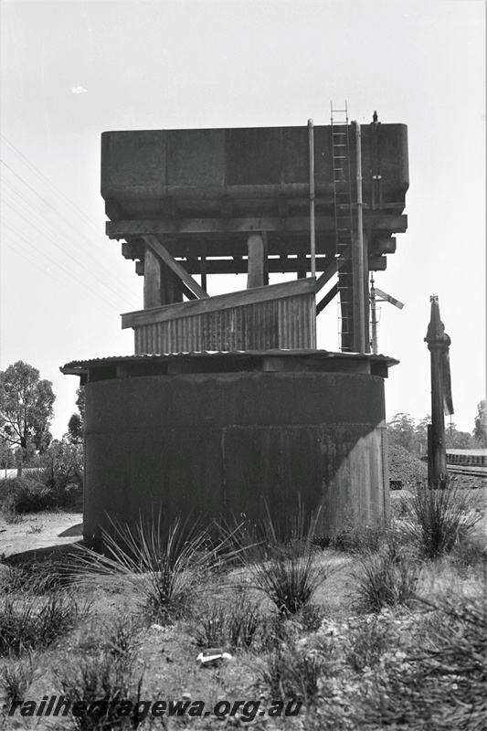 P22349
Water tower with 13000 gallon cast iron tank, water crane, sheds, Koojedda, ER line, view from beside tower at ground level
