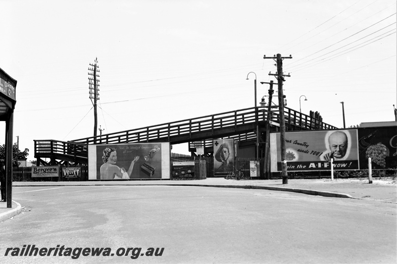 P22350
Pedestrian overpass, with billboards including one urging people to 