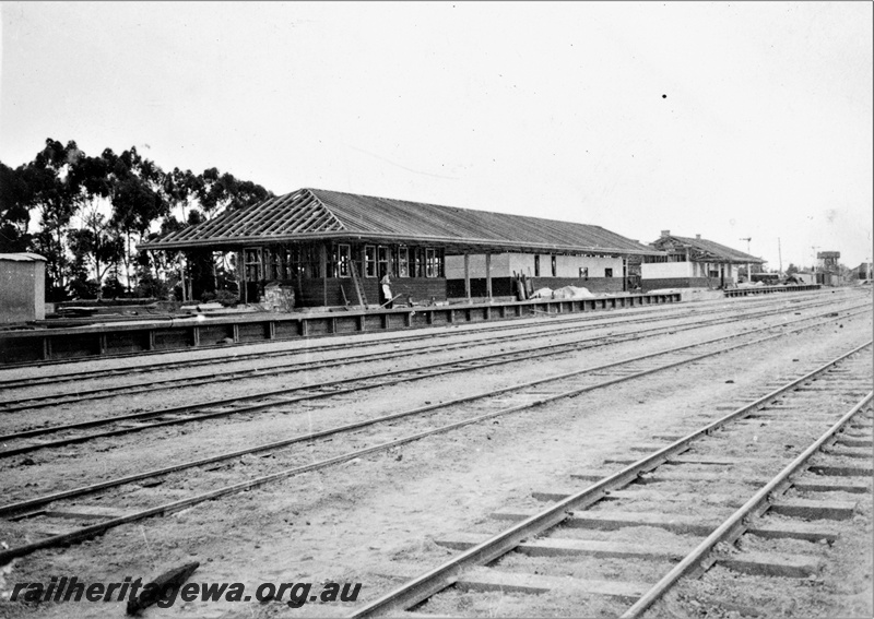 P22368
Construction of station building at Brunswick Junction SWR line 1 of 4, partly completed structure, platform, signal, water tower, view from track level
