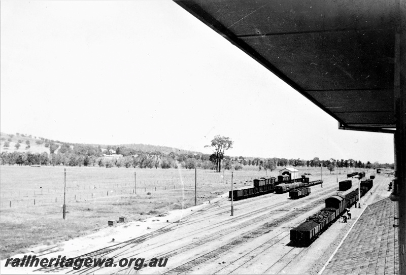 P22370
Construction of station building at Brunswick Junction SWR line 3 of 4, yard, wagons, vans, shed, workers, view from station roof
