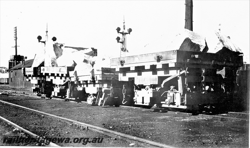 P22374
Perth stone train derailment 1 of 5, Public Works Department E class wagon 46, other wagons laden with stone, bracket signals, tracks, side and end view from trackside

