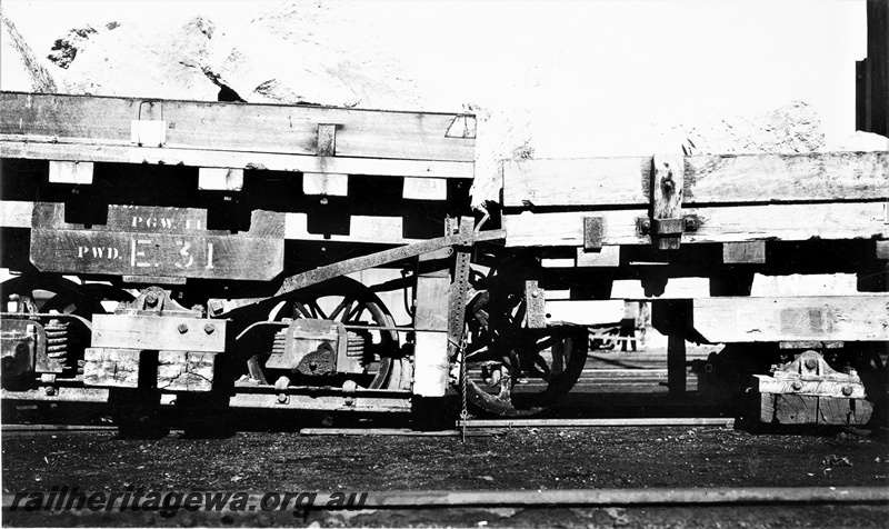 P22375
Perth stone train derailment 2 of 5, Public Works Department E class wagon 31, another wagon numbered 41, laden with stone and derailed, side view from trackside
