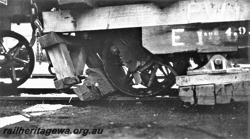 P22378
Perth stone train derailment 5 of 5, Public Works E class wagon 46, damage beneath, close up from trackside
