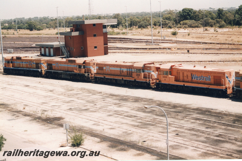 P22400
A class 1512, AB class 1533, A class 1505, A class 1506, another diesel loco (part), lashed up together, Hump Yard control tower, sidings, Forrestfield marshalling yard, side and end views 

