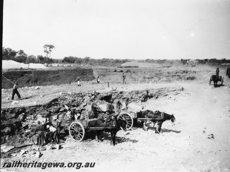 P22420
Preparing a railway water supply dam 2 of 3, horses, wagons, workers, roadway, view from elevated position
