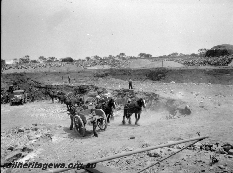P22421
Preparing a railway water supply dam 3 of 3, horses, wagons, motor vehicle, water pipe, ground level view
