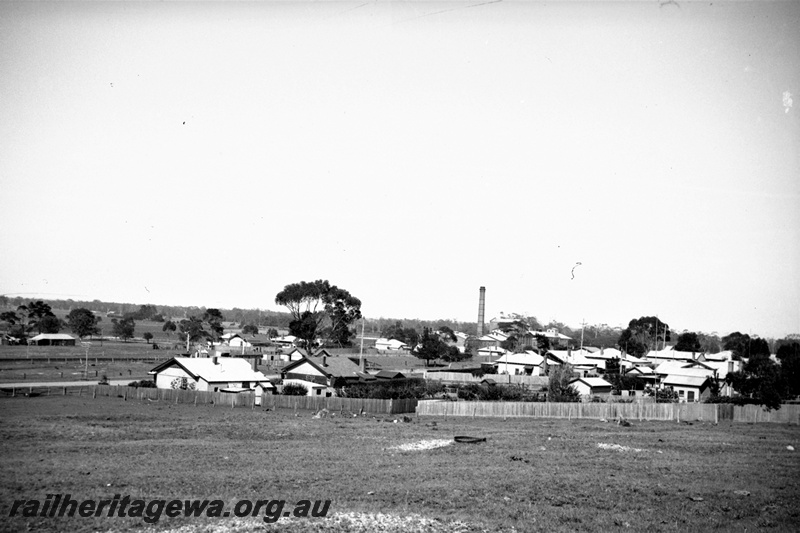 P22430
Overview of country town, smokestack, houses, fences
