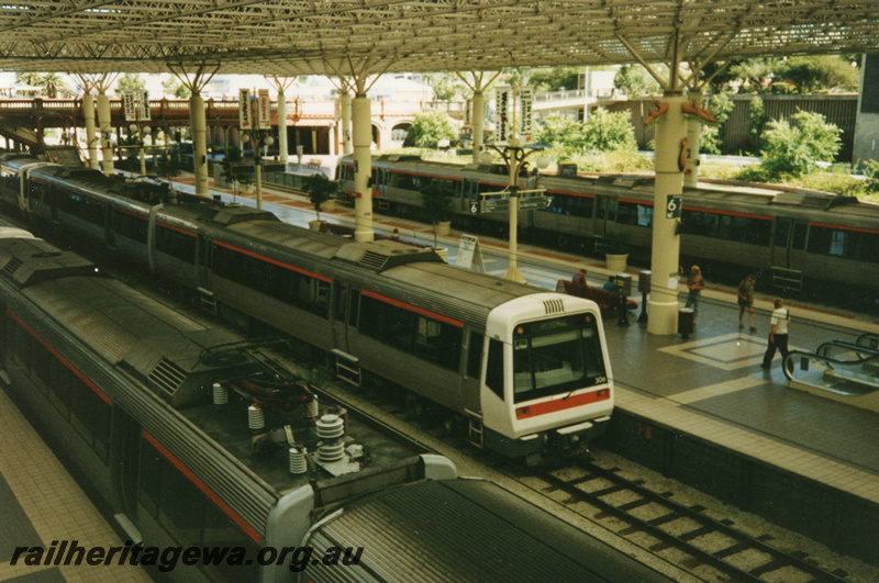 P22452
EMU A series  railcar set including trailer AEB class 306 ,two other EMU sets, platforms, roof, passengers, Perth station, view from elevated position
