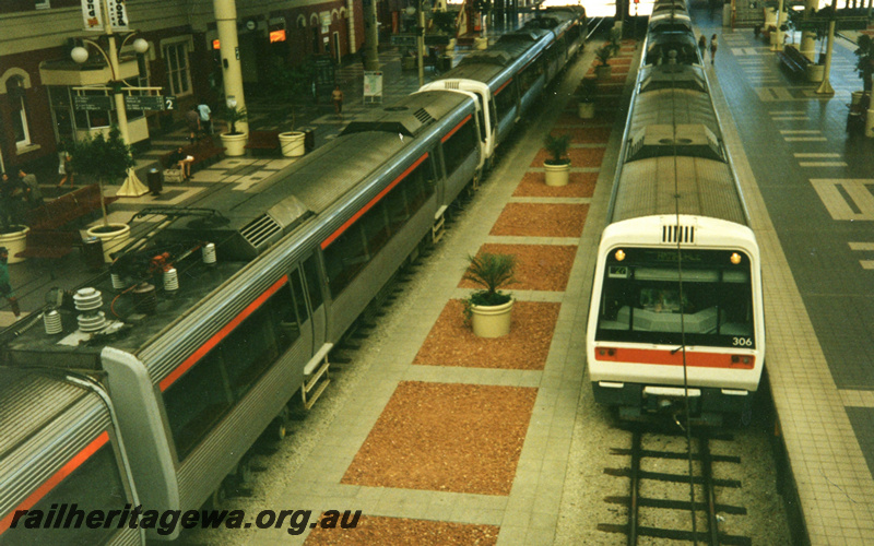 P22453
EMU A series  railcar set including trailer AEB class 306 , another EMU set, station building, platforms, passengers, Perth station, view from elevated position
