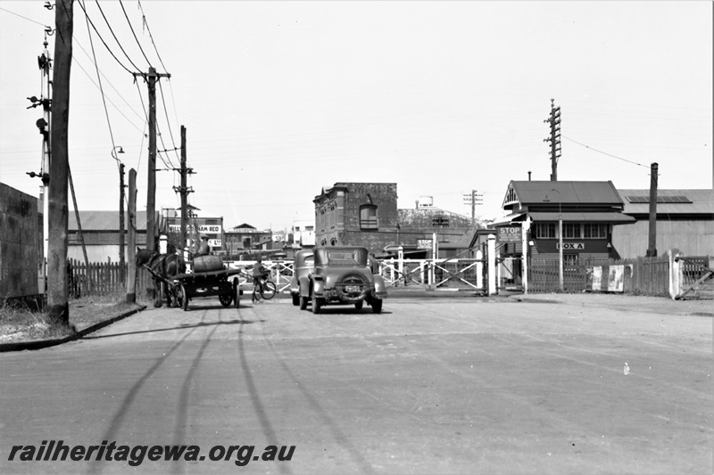 P22460
Level crossing, signal box A, motor vehicles, horse-drawn wagon, Melbourne Street, Perth, ER line, view from roadside

