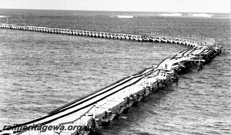 P22468
Storm damage to rails on Hopetoun jetty HR line 2 of 6, elevated view of jetty and damage, view looking out to sea
