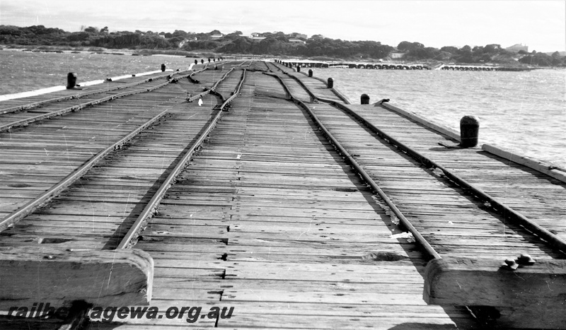 P22469
Storm damage to rails on Hopetoun jetty HR line 3 of 6, bollards, view of rails and jetty  looking towards land
