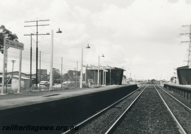 P22477
Oats Street station SWR line 5 of 5, platforms, shelters, station lights, tracks, telegraph pole, level crossing, view along the tracks from track level
