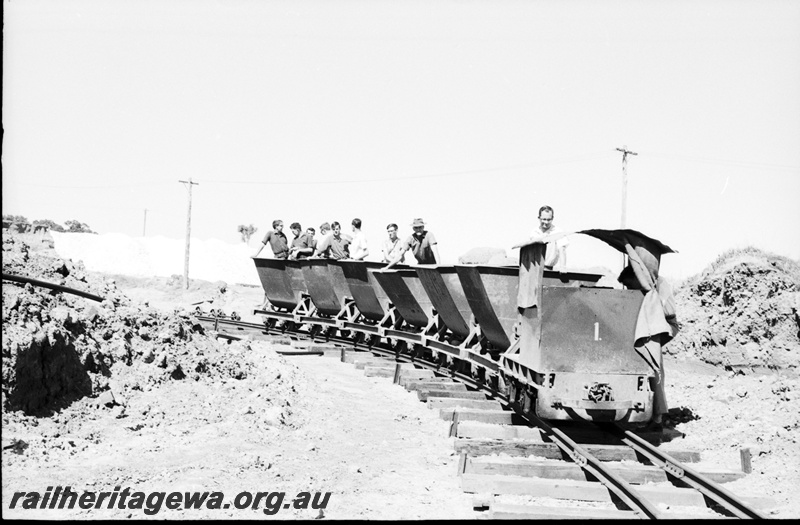 P22478
Australian Railway Historical Society Western Australian Division tour to Maylands brickworks 1 of 16, loco no 1 pulling 6 wagons with members aboard, side and front view from track level
