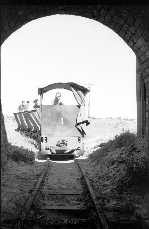 P22479
Australian Railway Historical Society Western Australian Division tour to Maylands brickworks 2 of 16, loco no 1 pulling wagons with members aboard into tunnel, side and front view from track level
