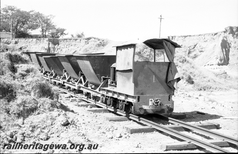 P22488
Australian Railway Historical Society Western Australian Division tour to Maylands brickworks 11 of 16, loco no 1 on train of 6 wagons, tracks, cutting, side and front view
