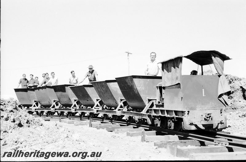 P22489
Australian Railway Historical Society Western Australian Division tour to Maylands brickworks 12 of 16, loco no 1 on train of 6 wagons, with members aboard, side and front view
