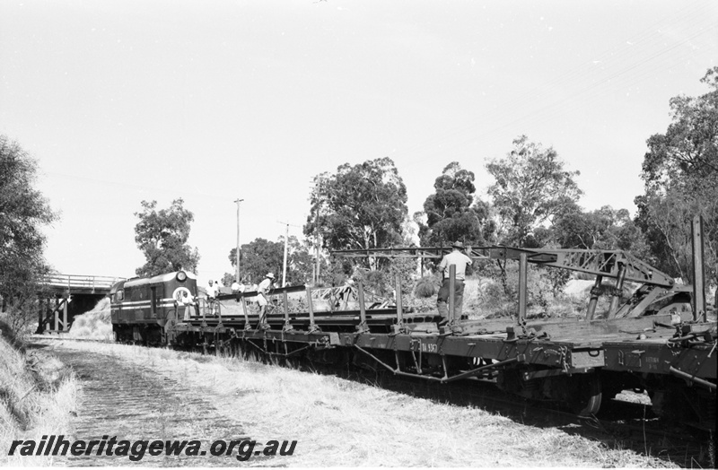 P22503
Rail reclamation on the ER 10 of 10, F class 43 on rail recovery train including QA class 9367 flat wagon, loading rails at Morrison Road overpass, trackside crane, workers, ER line, side and end view
