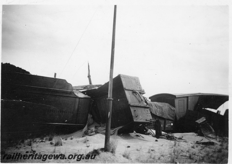 P22562
Derailment of 14 wagons of No 77 Fast Mixed near Konnongorring EM line on 8 January 1949 No 6 of 6, tender of ES class 294, derailed wagons, van, side view at track level
