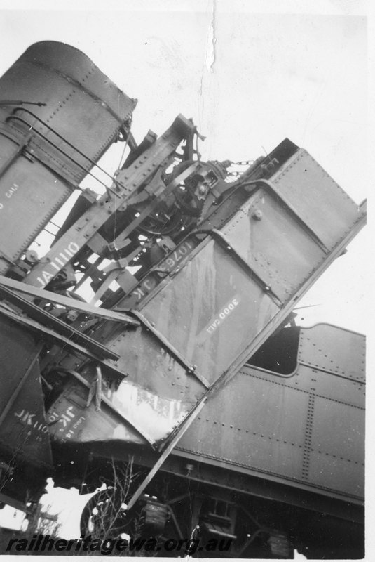 P22565
Head on collision of PR class 530 and PR class 531 on No W7 Water Train and No 76 Goods near Botherling EM line on 20 April 1950 No 3 of 7, JA class 11110, JK class wagon, derailed and up against locomotive tender, side view from trackside
