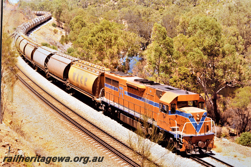 P22573
L class 258 in Westrail orange with blue and white stripes, on train of empty grain wagons, Avon Valley line, side and front view 
