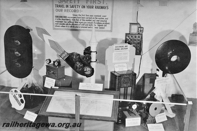 P22574
Safety equipment display, including semaphore and colour light signals, signal box equipment, track diagram, on display inside building, c1940s
