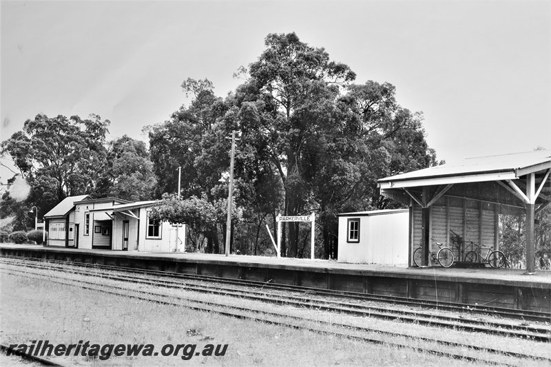 P22581
Station buildings, platform, name boards, signal box, sheds, open shelter for passengers with bicycles, Parkerville, ER line, c1966. Similar to P00616
