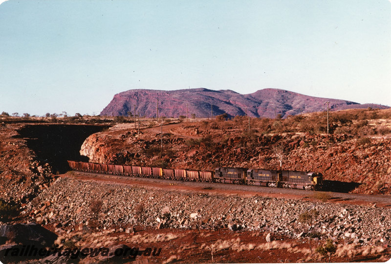 P22589
Hamersley Iron locomotives 4050, 3017 and 4052, triple heading up iron ore train, 276 km, Pilbara, side and front view

