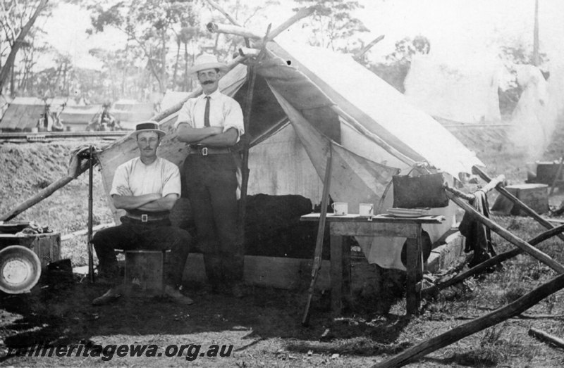 P22740
George Stevens and Ivan Bates, in front of tent, table, mugs, bunks, water bag, Great Southern Railway Construction camp, GSR line, c1886-1889
