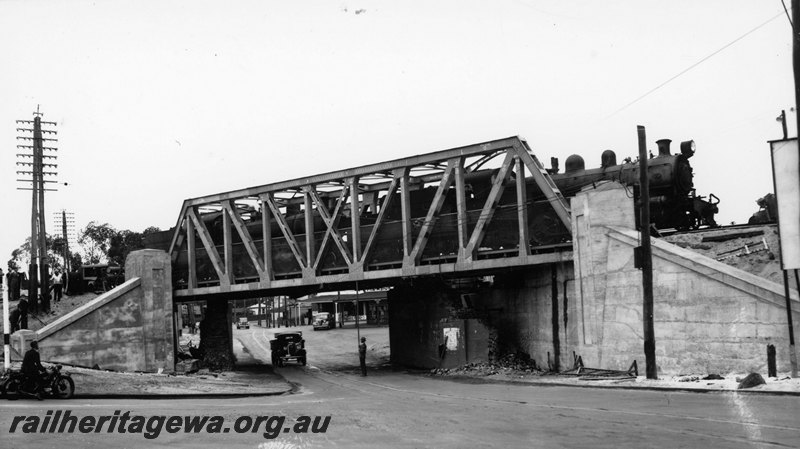 P22760
Extension of Mt Lawley subway ER line No 9 of 15, deflection test, two steam locomotives on bridge, motor cyclist, truck passing under the bridge, view looking towards the west from road level
