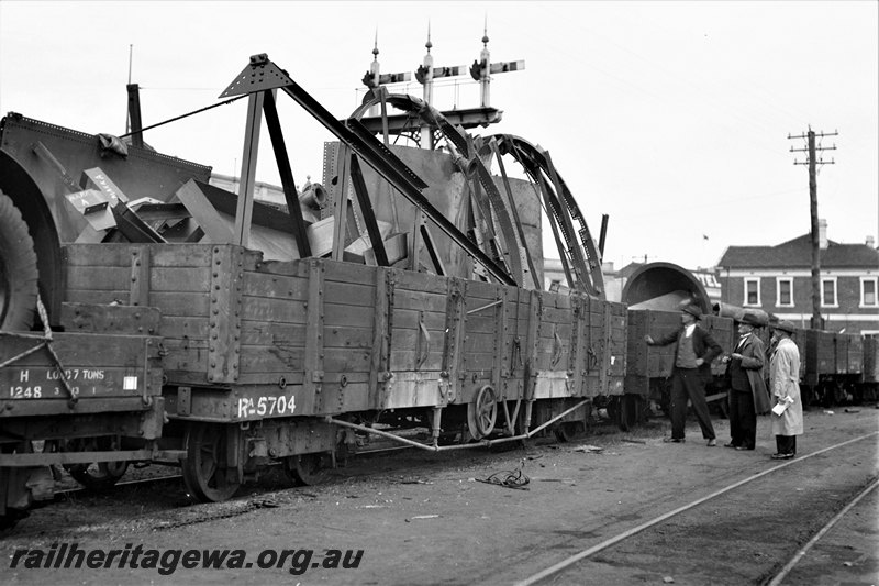 P22777
RA class 5704 5 plank wagon loaded with water tanks and fixings 1 of 4, H class 1248 wagon (part), other wagons, bracket signals, onlookers, Fremantle, ER line,  end and side view from trackside
