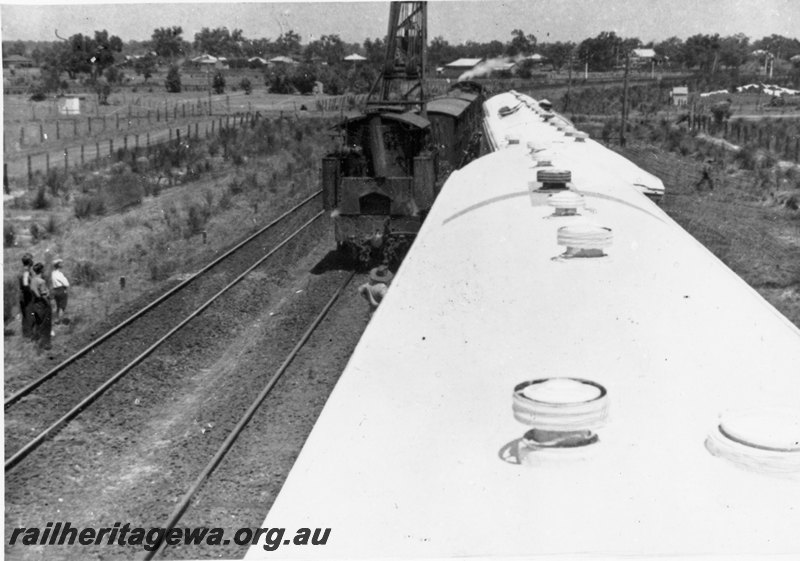 P22784
Derailment of army ambulance train 10 AAT, steam hauled rescue train with vans and mobile crane, derailed white carriages, onlookers, near Bellevue (in background), ER line, view of scene from elevated position
