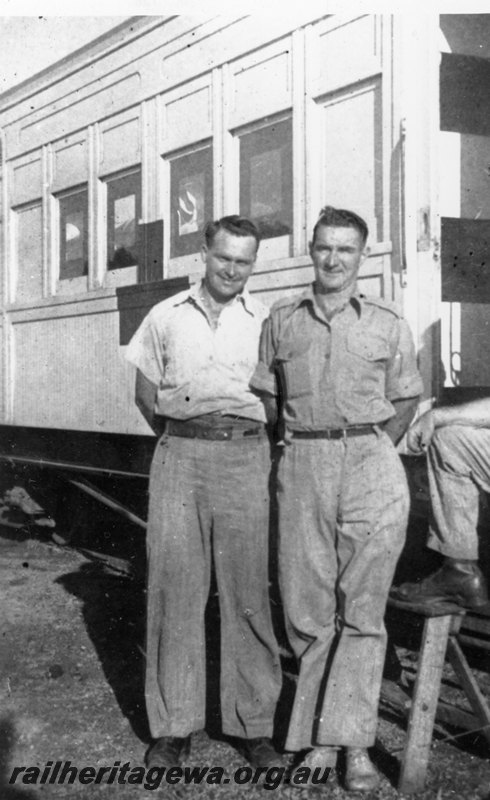 P22787
Photo of Cpl Clune, Pte B. Morris and Pt Warner, step-ladder, standing in front of ambulance carriage white with red cross, taken from trackside
