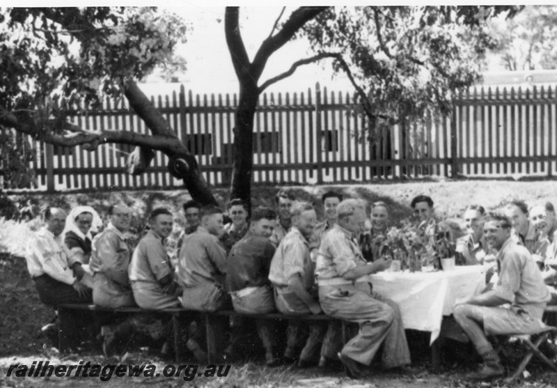 P22789
1st birthday party, army ambulance train 10 AAT, staff members seated at table outdoors, ground level view
