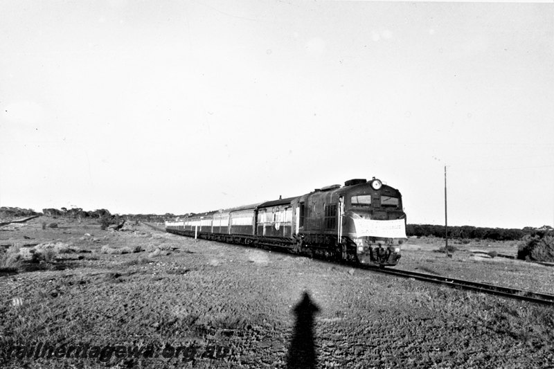 P22803
X class diesel, on last No 86 passenger train ex Kalgoorlie, passing location of old Kurrawang station, EGR line, side and front view
