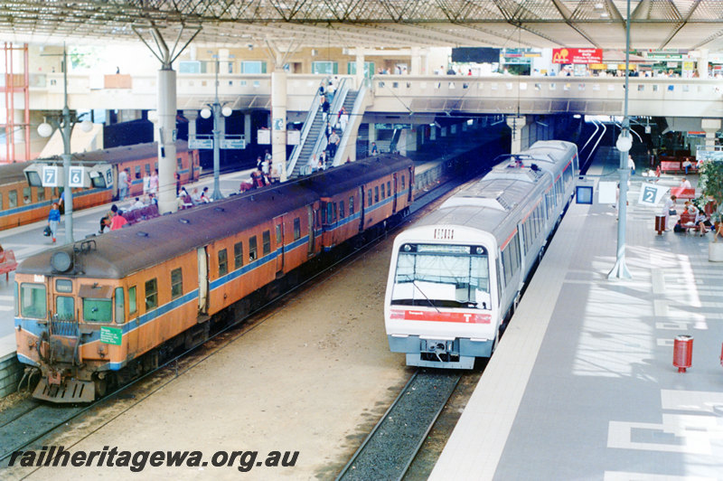 P22898
ADG class 607 on DMU, another DMU, on Fremantle and Midland services, EMU on Armadale service, awaiting departure, platforms 2, 6 & 7, overhead footbridge, escalators, roof, Perth City station, ER and SWR lines, front and side views from elevated position
