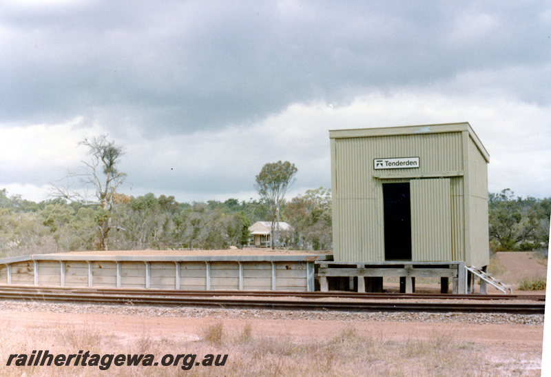 P23057
Platform, station shed with sign, house in bush, track, Tenterden, GSR line, trackside view 
