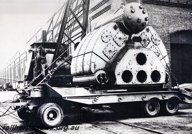P23525
Yarrow class boiler No. 12 (for HMAS Corvettes) being loaded by steam crane on to an AIF trolley, Midland Workshops 
