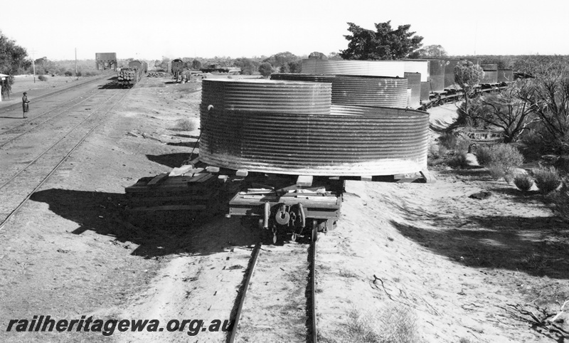 P23629
Water tanks being transported on flat wagons, tracks, water tower,  Karalee, EGR line, end view
