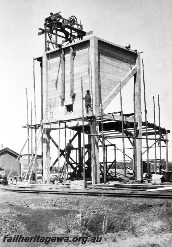 P23663
Coal stage under construction, 3of 4, workers, other trackside sheds, Caron, MR line, view of structure from across tracks
