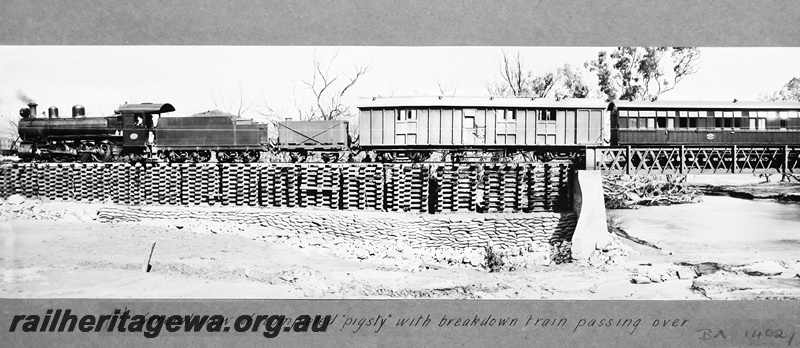 P23676
MRWA locomotive A class 14 on breakdown train including KB class workman's van,  GR class water tanker, and J/JA class carriage, on pigsty adjacent to cast iron truss bridge over the Irwin River, MR line, side view
