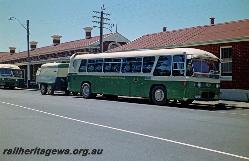 P24209
Railway Road Service  bus L81 WAG8981, with trailer, front portion of another bus, station buildings fronting roadway, Bunbury, SWR line, side and front view
