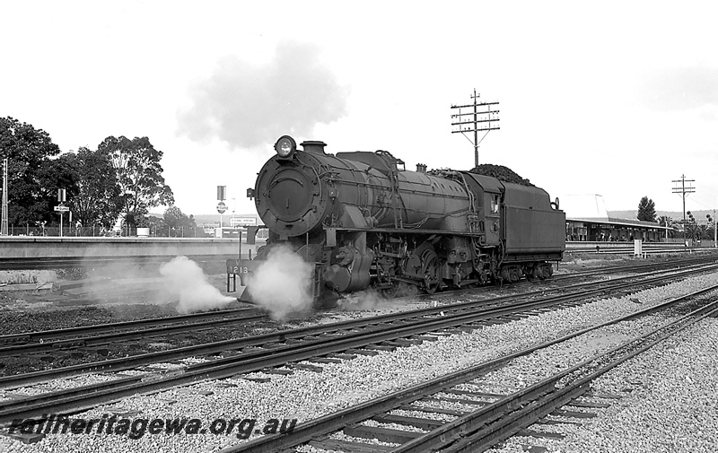 P24221
V class 1213, running light, passing Midland Station, platform, building, tracks, gantry light signals, ER line, front and side view
