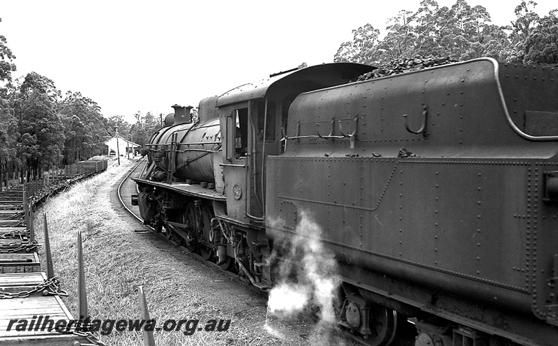 P24236
W class 940, rake of flat wagons with bolsters in adjacent siding, small weatherboard station building and platform, Pemberton, PP line, side and rear view
