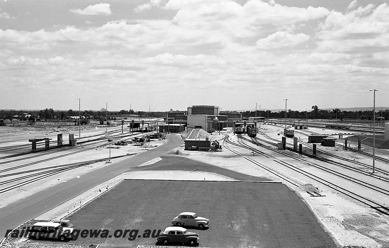 P24256
Locomotive depot, various facilities, locomotives, tracks, sidings, carpark with motor vehicles, elevated view from tower
