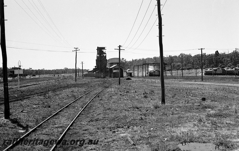 P24273
Steam locomotives, coal stage, gantry, water tower with Braithwaite tank, goods shed, yard, Collie, BN line, long view from track level
