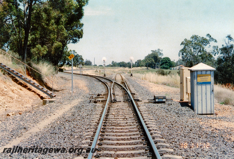 P24308
Trackwork , speed restriction sign, whistle sign, rear of searchlight signals, point work point motor, relay boxed, small cabin housing the Crank handle, Telephone and the Pilot Key, view from track level looking along the track Brunswick East
