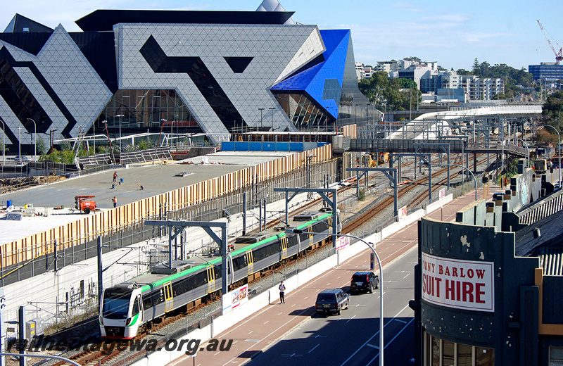 P24321
EMU set 56 comprising BEA, BEB and BET class railcars, Yagan Square construction and Perth arena in background, Perth, Joondalup line, end and side view
